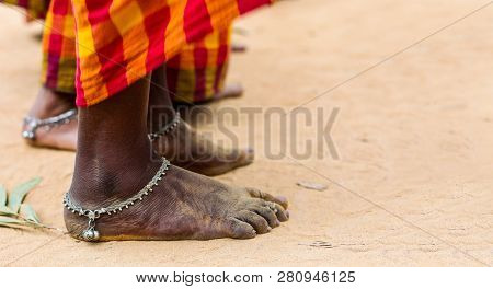 Dirty Bare Feet Of Tribal Female Dancer In Saree With Anklet In Tribal Dance Pose Stance On Ground