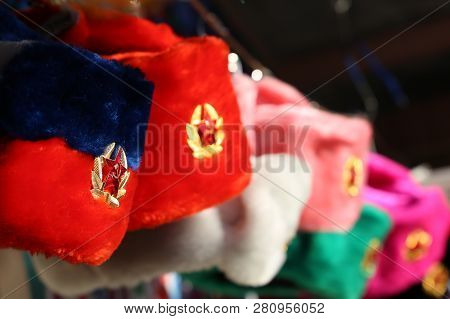 Earflaps Fur Caps With Red Stars In A Souvenir Shop In Moscow. Winter Hats, Soviet And Russian Milit