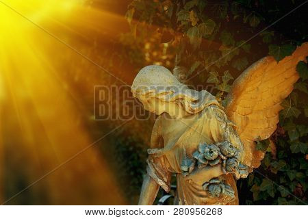Guardian Angel Statue In Sunlight As A Symbol Of Strength, Truth And Faith. Religion Tradition.