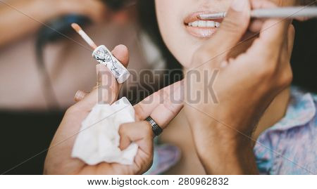 Makeup Artist Applying Lipstick For A Young Asian Woman During Getting Ready For Wedding Ceremony