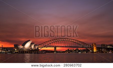 Sydney, Australia - July 1 2014: A Shot Of A Brilliant Red Sunset Behind The Sydney Opera House