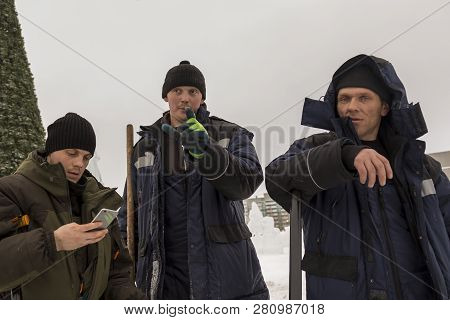 Three Workers At The Installation Of The Ice Town