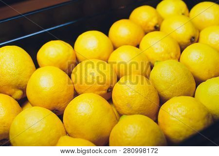 Fresh Lemons In A Wooden Box. On The Black Chalkboard.