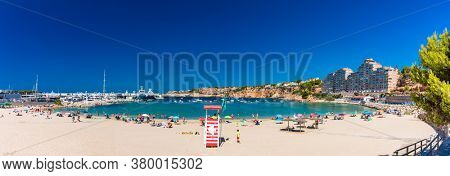 PORT ADRIANO, MALLORCA, SPAIN - 23 July 2020 - Tourists enjoying summer day on the popular city beach.