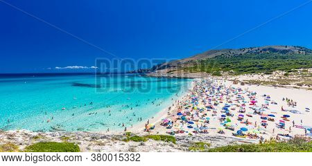 CALA MESQUIDA, MALLORCA, SPAIN - 19 July 2020: People enjoying beautiful sandy beach of on Mallorca, Mediterranean Sea, Balearic islands, Spain.