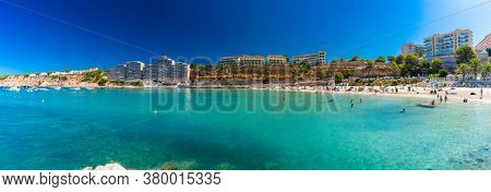 PORT ADRIANO, MALLORCA, SPAIN - 23 July 2020 - Tourists enjoying summer day on the popular city beach.