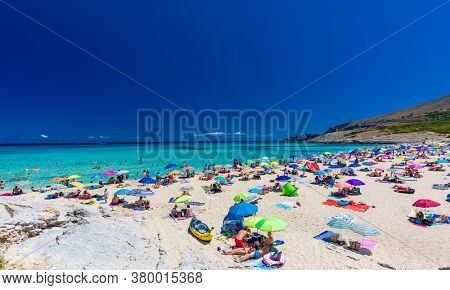 CALA MESQUIDA, MALLORCA, SPAIN - 19 July 2020: People enjoying beautiful sandy beach of on Mallorca, Mediterranean Sea, Balearic islands, Spain.