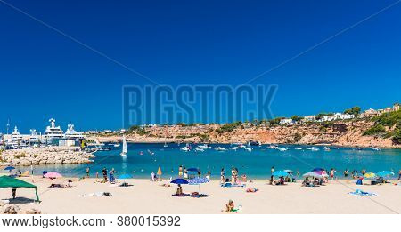 PORT ADRIANO, MALLORCA, SPAIN - 23 July 2020 - Tourists enjoying summer day on the popular city beach.