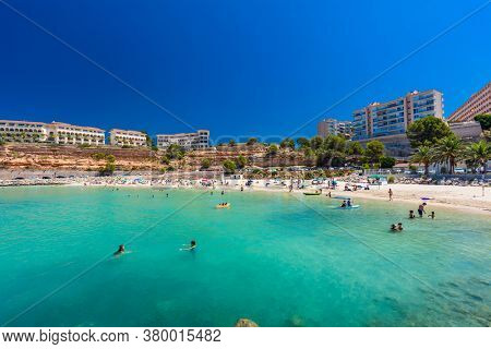 PORT ADRIANO, MALLORCA, SPAIN - 23 July 2020 - Tourists enjoying summer day on the popular city beach.