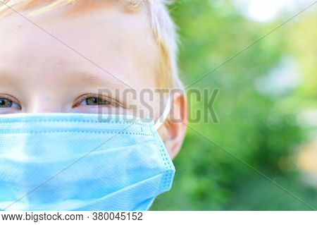 Close-up Portrait Of A School-age Boy With A Protective Medical Mask On Her Face. New School Year In