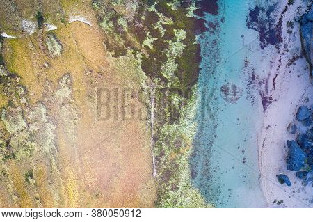 Geger Beach Shore With Green Seaweeds Rocks By The Beach. Bali, Indonesia