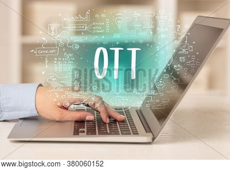 hand working on new modern computer with OTT abbreviation, modern technology concept