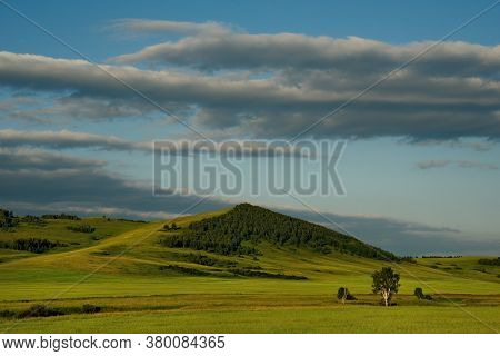 Russia. Republic Of Khakasia. Endless Steppes Among Picturesque Hilly Mountains Near The Village Of 