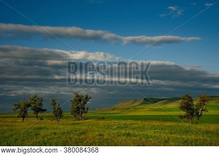 Russia. Republic Of Khakasia. Endless Steppes Among Picturesque Hilly Mountains Near The Village Of 
