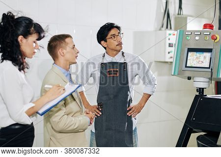 Businessman Asking Coffee Roastery Worker About New Modern Roaster Machine