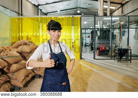 Portrait Of Happy Excited Female Coffee Roastery Owner Showing Thumbs-up And Looking At Camera