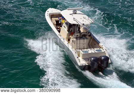 Angled Overhead View Of An Open Sports Fishing Boat Powered By Two Outboard Engines.
