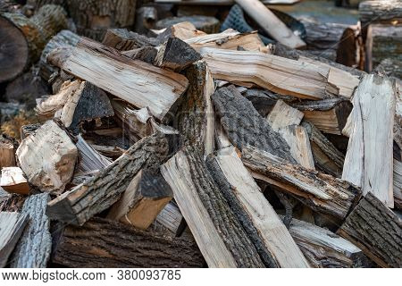 Outdoor Shot Of A Stacked Pile Of Firewood Lit By Beautiful Warm Rays Of Sunlight, Feedstock