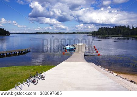 Latvia, Aluksne, August, 2020 - Wooden Pier For Motor Boats On A Beautiful Large Lake In Aluksne