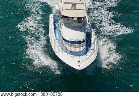 Elevated Head On View Of A Sport Fishing Boat Racing On Biscayne Bay Off Of Miami Beach.