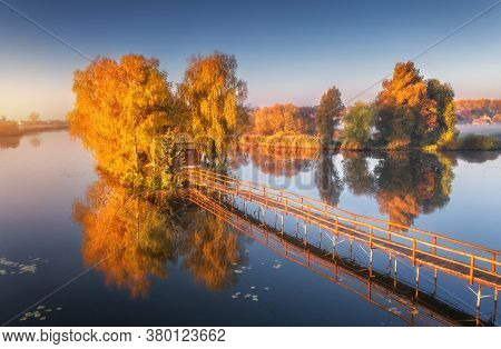 Old Fisherman House And Wooden Pier At Sunrise In Autumn. Aerial View. Beautiful Landscape With Hous
