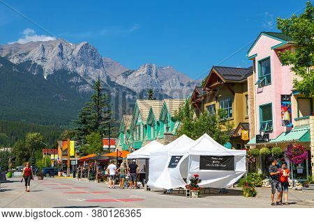 Canmore, Canada - July 30, 2020: Tourists Walking And Dining Along Popular Downtown Canmore In The C