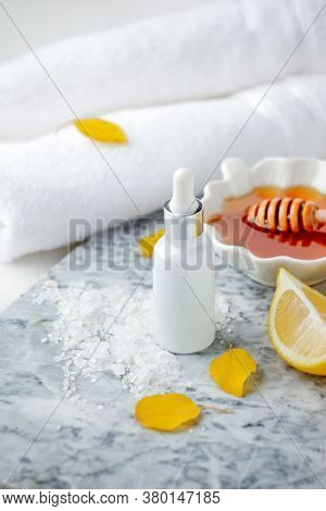 Facial Treatment Preparation. Simple Homemade Facial Mask And Spa Products, Honey, Lemon And Bottle 