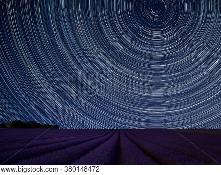 Digital Composite Image Of Star Trails Around Polaris With Stunning Vibrant Landscape Of Beautiful L