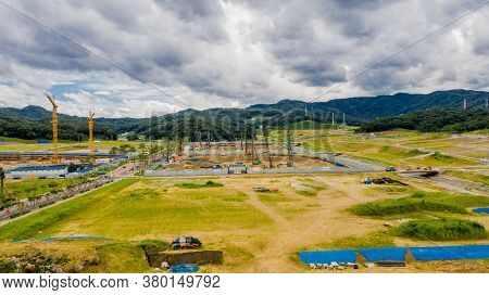 Aerial View Of Construction Site Under Ominous Clouds