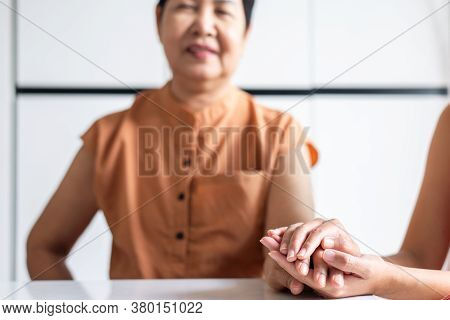 Woman Holding Hands To Elderly With Alzheimer Disease At Home,adult Social Care Concept
