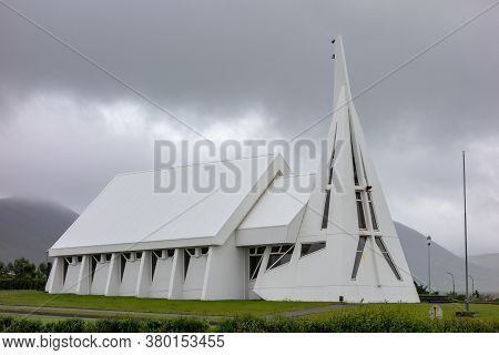 Skagastrond, Iceland - July 6, 2014: Futuristic Holaneskirkja Church Of Modern Architecture With Whi