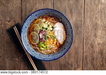 Top View On Summer Cold Ramen Noodle Soup With Chicken In A Bowl With Chopsticks