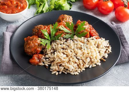 Beef Meatballs And Brown Rice On A Plate. Ready Made Portioned Dish Meat With Garnish.