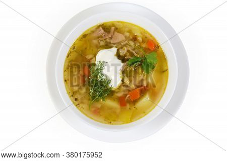Serving Of Rassolnik - Meat Soup With Pearl Barley And Pickled Cucumbers Seasoned With Sour Cream, T