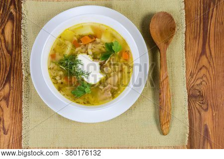 Portion Of Rassolnik - Meat Soup With Pearl Barley And Pickled Cucumbers Seasoned With Sour Cream, W