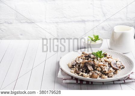 Risotto With Mushrooms On A White Plate. Boiled White Rice With Champignons In Cream Sauce. Light Wo