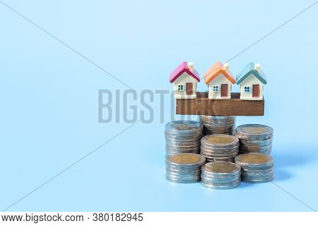 Mini House On Stack Of Coins,money And House,  Mortgage, Savings Money For Buy House And Loan To Bus