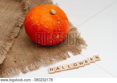 Orange Pumpkin Vegetable Onon Brown Bag And The Inscription Halloween From Wooden Blocks