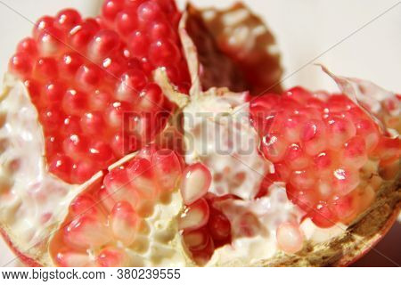 Broken Ripe Pomegranate Close Up. Ripe Seeds Of Pomegranate Close Up. Delicious Fruits. Useful Food.