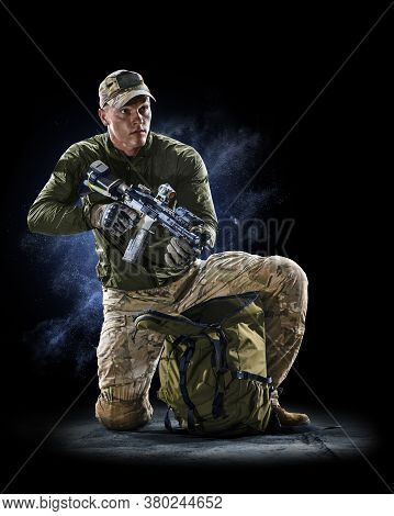 Army Soldier In Protective Combat Uniform Holding Special Operations Forces Combat Assault Rifle On 