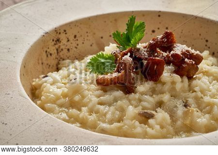 Risoto With Chanterelle Mushrooms In Large Plate. Side View, Close Up