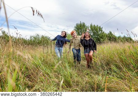 Summer Holidays Vacation Happy People Concept. Group Of Three Friends Boy And Two Girls Running And 