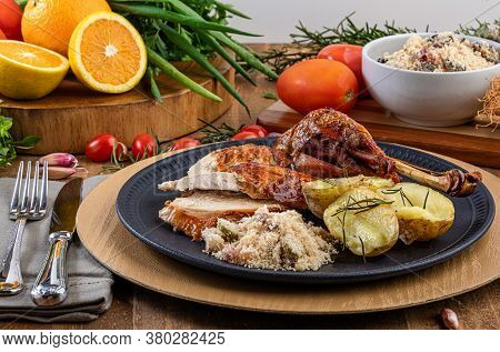 Roasted Turkey Served On A Plate With Farofa, Crumbs And Boiled Potatoes. Thanksgiving Day And Chris