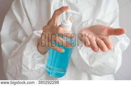 Healthcare Worker Wearing Ppe Suit And Using Hand Sanitizer Gel For Clean Her Hands. Washing Your Ha