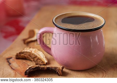 Mushroom Coffee Chaga Superfood. Dried Mushrooms And Fresh Brewed Cup Of Hot Drink On Wooden Backgro