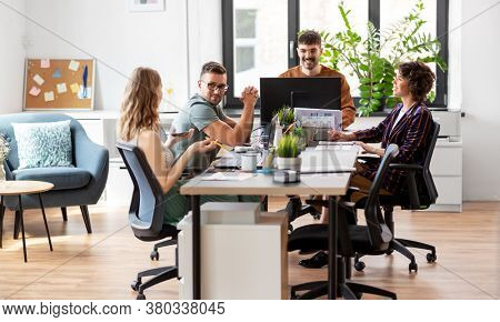 business, people and corporate concept - team of startuppers or ui designers working at office