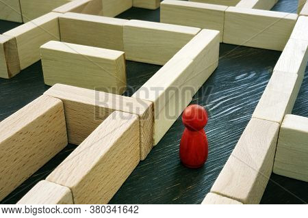 Red Figurine Inside The Maze. Business Challenge And Finding A Solution To The Situation.