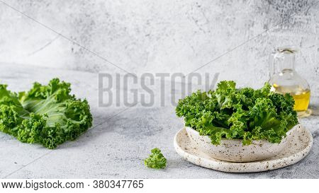 Green Kale Leaves In White Craft Bowl On Gray Cement Background. Healthy Eating, Vegetarian Food, Di