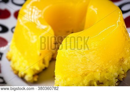 Piece Of Quindim, Small Pudding Cut From Brazilian Egg, With Sugar And Grated Coconut. Macro Or Clos