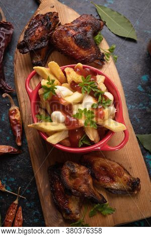 Canadian poutine, fried potato chips with cheese and gravy or sauce